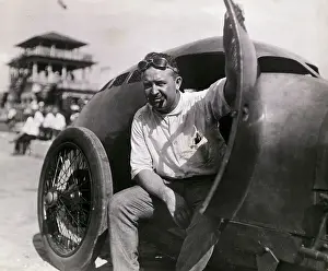 Cooperation Prints: Racecar Driver Barney Oldfield Pausing in Racecar
