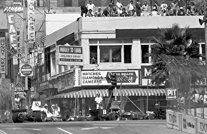 Prints of LONG BEACH, CALIFORNIA - SEPTEMBER 28 : Race fans watch cars turn onto Ocean Blvd Legends of the Track: Racers at Inaugural Grand Prix of Long Beach 1975