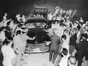 Blocking Prints: Racist Protesters Surrounding Automobile