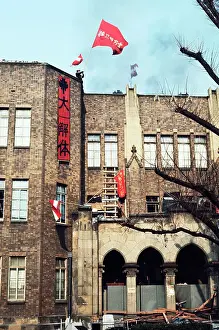 Radical Student Waving Flag from Roof
