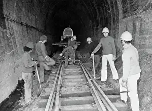 Hard Prints: Railroad Workers Constructing Tracks Through Tunnel