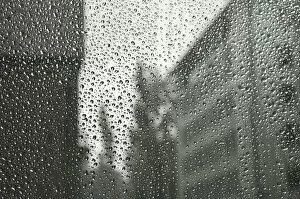 Raindrop Gallery: Rain drops on a window pane, blurry buildings in the back
