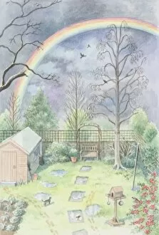 Rainbow arching over domestic garden, against cloudy sky