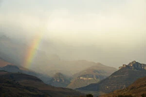 Images Dated 12th June 2010: Rainbow at the base of the Amphitheatre range in the Drakensberg Mountains, Royal Natal