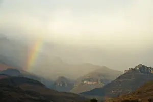 Peacefulness Prints: Rainbow at the base of the Amphitheatre range in the Drakensberg Mountains