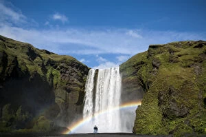 Rainbow, couple watching the Skogafoss waterfall on the Skoga river, ring road, Suourland, Sudurland, southern Iceland