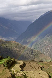 Rainbow over rural mountain valley