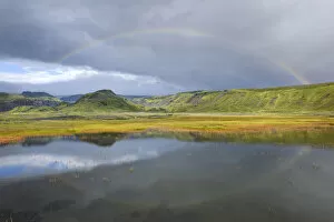 Rainbow over a small lake near Soelheimajoekulsvegur, Iceland