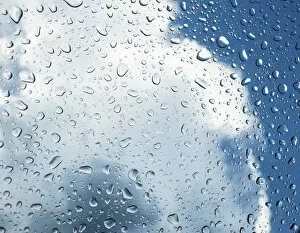 Raindrop Gallery: Raindrops on a window in front of storm clouds