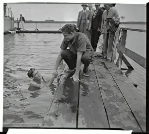 Ralph Flanagan in Pool Shaking Hands with Adolph Kiefer