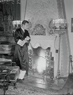 Randolf Scott Leaning Against Fireplace