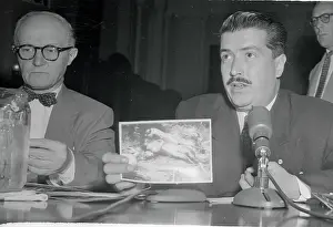 Raul Midence Holding a Photograph