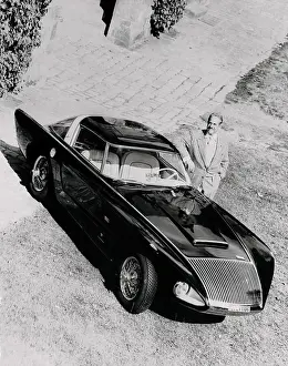 Raymond Loewy Posing Next to a Car