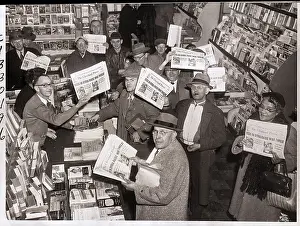 Readers Hold Up Newspapers in Bookstore