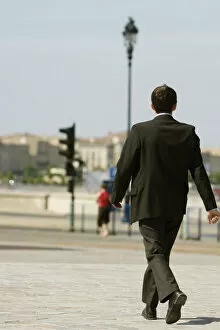Images Dated 10th July 2008: Rear view of a businessman walking on a sidewalk, Bordeaux, Aquitaine, France