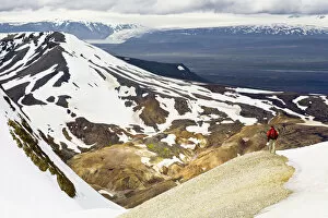 Rear view of man hiking down a mountain