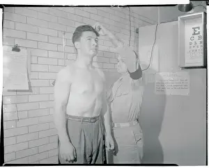 Recruiting Officer Measuring Boys Height and Weight