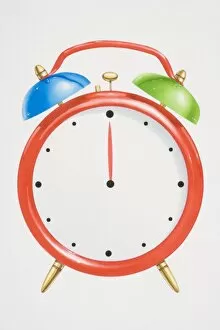 Red alarm clock with green and blue bells on top