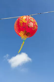 Red Chinese New Year lantern against blue sky, Songkhla, Thailand