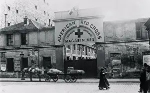 Red Cross Building with Pedestrians and Wagon in Front