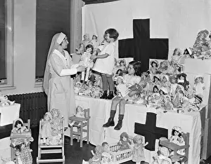 Red Cross Prints: Red Cross Nurse with Girls Surrounded by Dolls