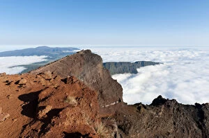 Red volcanic rock on the summit, Piton des Neiges Mountain, 3069 m, above the clouds, near Cilaos