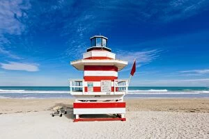 Red and white striped lifeguard hut stylized as lighthouse in South Beach, Miami, Florida, USA