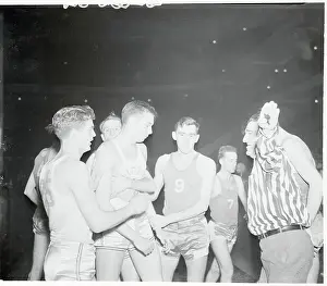 Prints of (Original Caption). No, No. Not Tonight! New York, New York: Basketballers at Madison Square Garden evidently got basketball night mixed up with fight night Hoops Through Time: A Visual Journey of Basketball History: Referee Calming Basketball Players