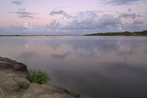 Embankment Prints: Reflected clouds in shoreline estuary system with embankment in foreground