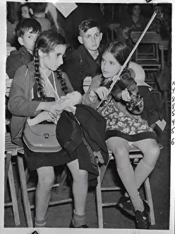 Refugee Musicians Performing on Stools
