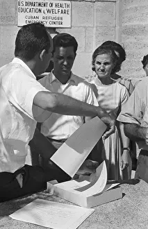 Refugees Looking over Forms