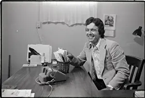 Rennie Davis Working at Desk in Office