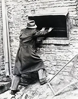 Reporter Examines Window of Cocoanut Grove