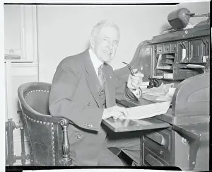 Representative John Steven McGroaty Sitting at Desk With Pipe