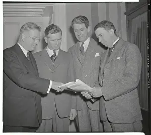 Representatives Looking at Magazine