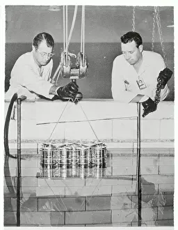 Researchers Lowering Cans Into Reactor
