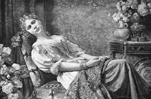 Contemplative Prints: Resting, young woman sitting in an armchair in the living room on Sunday afternoon