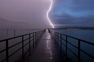 Images Dated 6th August 2011: Retreating thunderstorm, left, and magic hour with lightning, right, jetty of Konstanz Therme