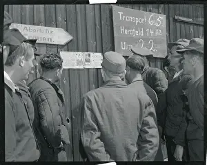 Returning POWs Viewing Photos of Comrades