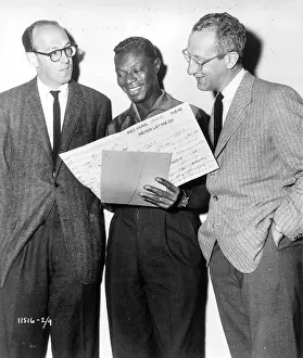 Prints of 1955: Entertainer Nat King Cole looks over the sheet music for the song Never Let Me Go which was released as part of the soundtrack to the movie The Scarlet Hour in 1956 A Musical Icon: Reviewing Never Let Me Go Sheet Music
