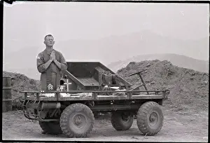 Prayer Prints: Rev.Kneels In Prayer On Military Vehicle