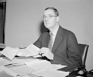 Richard M. Bissell Jr. Seated at Desk