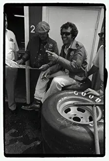 Richard Petty Seated on Tires and Laughing
