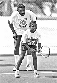 Prints of With her coach and father, Richard WIlliams, behind her, American tennis player Serena Williams, 9, waits for a serve during a training session at the Compton tennis courts The Grand Slam Gallery: Richard & Serena Williams On Compton Tennis Court