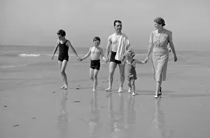 Prints of 8th October 1938: English jockey Gordon Richards (1904 - 1986) on the beach near his home in Shoreham, West Sussex, with his wife and children Chronicling Britain's Story in Pictures: Richards Family