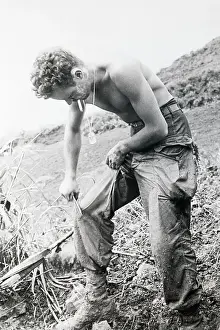 Scraping Prints: Rifleman Scraping Mud From His Trousers