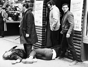 Riot Victims Lying Injured on Sidewalk