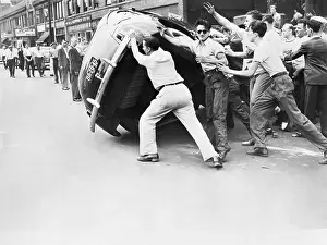 Rioters Toppling a Car