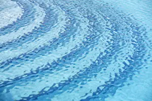 Basin Prints: Rippled water surface in a swimming pool, detail, blue with steps below the surface