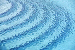 Surface Gallery: Rippled water surface in a swimming pool, detail, blue with steps below the surface
